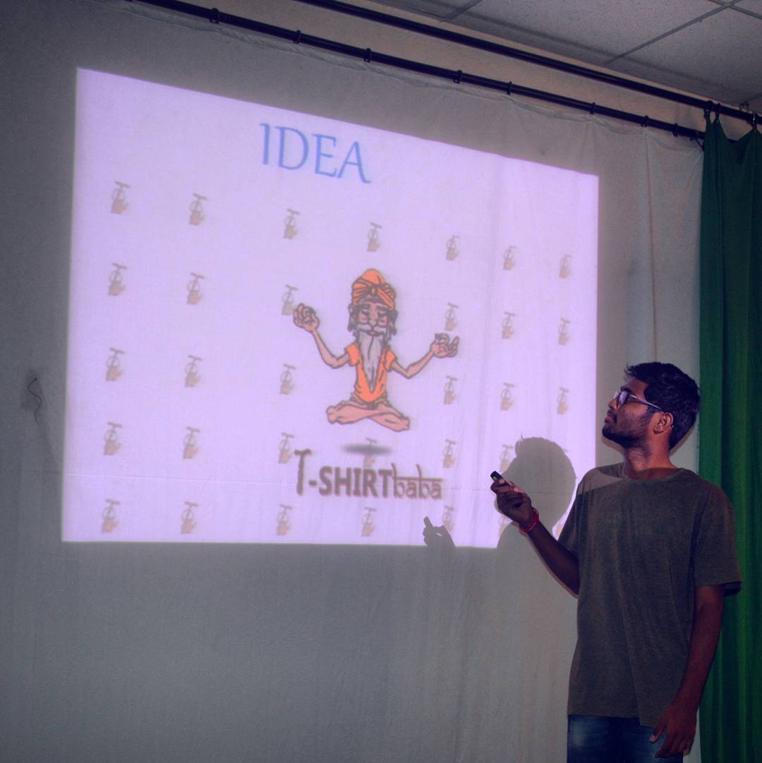 Vamshi pitching his first startup T-Shirt Baba in front of a projector